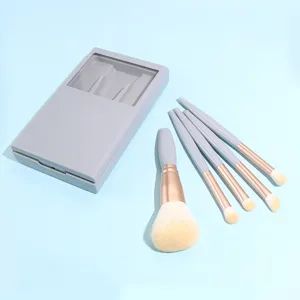 Detail view of 5-piece portable makeup brush set with grey case and soft bristles for travel.
