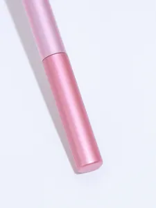 Pink makeup brush handle detail, soft bristles aesthetic cosmetic tool close-up view.