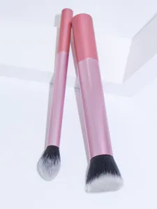 Pink makeup brush set detail view showing soft black and white gradient bristles closely.