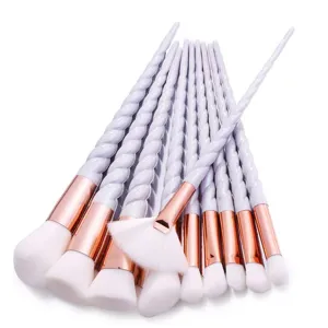 Detailed close-up of unicorn makeup brush set, featuring twisted handle and soft white bristles.