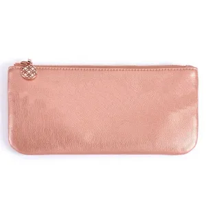Close-up detail of the rose gold cosmetic pouch zipper pull and metallic leather texture.