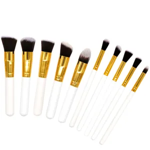 Ensemble de 10 pinceaux de maquillage avec manches blancs et ferules dorees pour application pro.