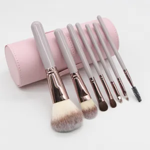 Σετ πινέλων μακιγιάζ 7 τεμαχίων με παστελ μοβ λαβές και ροζ κυλινδρική θήκη.