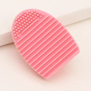 Pink silicone makeup brush cleaning egg tool, portable scrubber for easy cosmetic brush wash.