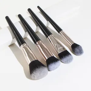 Makeup brush set detail closeup showing black handles, rose gold ferrules and soft bristles.