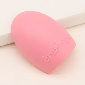 Pink silicone makeup brush cleaner egg detail view for easy cosmetic tool washing and care.
