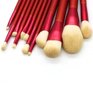 Detailed view of the 12-piece red makeup brush set, featuring soft beige bristles and handles.