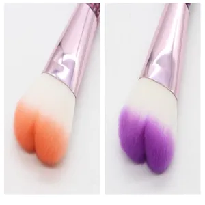 Heart-shaped makeup brush detail view showing dual color options for blush and powder use.