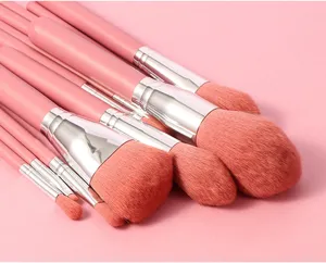 Detailed view of soft pink makeup brushes set with silver ferrules for smooth daily cosmetic use.