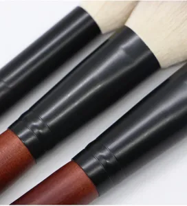Professional makeup brush detail, soft hair bristles, durable wooden handle, cosmetic tool.