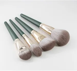Detailed view of green handle makeup brush set soft bristles beauty tool closeup.