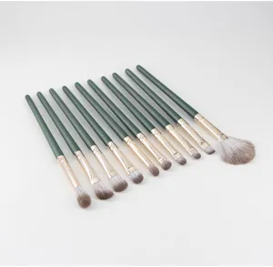 Detailed view of green handle makeup brush showing soft bristles and metal ferrule design.