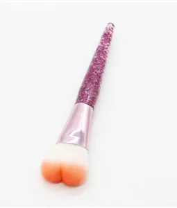 Heart shaped makeup brush with purple glitter long handle and gradient blush powder brush tool.