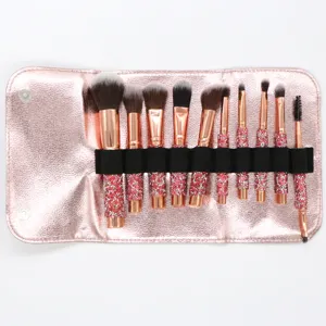 10-piece rhinestone makeup brush set with pink roll bag, professional cosmetic tool main view.