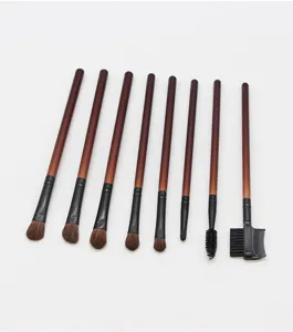Detailed shot of professional makeup brush set with wooden handles and soft bristles.