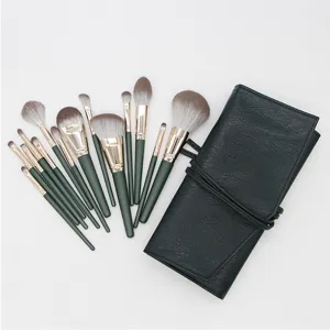 14-piece makeup brush set with dark green wooden handles and roll-up leather storage bag.