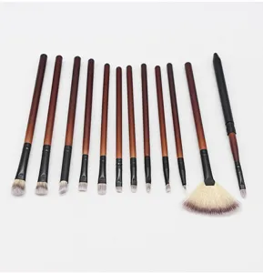 Detailed view of professional makeup brush set with gradient brown handles and soft bristles.