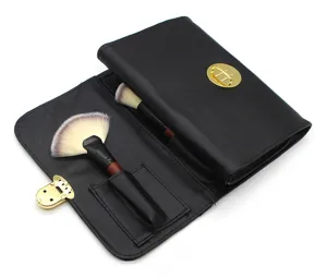 Portable black leather makeup brush storage bag organizer featuring secure golden lock hardware detail.