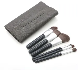 Detail view of 6-piece makeup brush set with grey PU leather storage case neatly arranged.