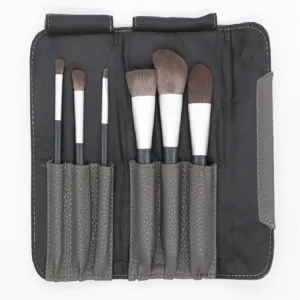 Detail shot of a 6-piece makeup brush set with a dark PU leather roll pouch for easy storage.