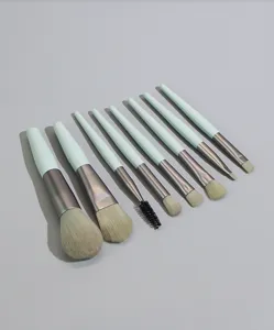 Detailed view of the 8-piece mini makeup brush set featuring soft bristles and green handles.