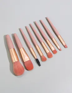 8-piece mini makeup brush set with pink wooden handles, soft bristles for face and eyes.