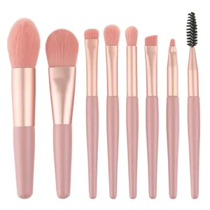 8-piece mini makeup brush set with pink handles and rose gold ferrules for professional use