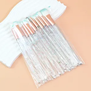 Detailed close-up view of crystal glitter makeup brush set with rose gold ferrule in transparent bag.