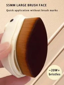 Close-up of 55mm large makeup brush with dust cover and dense bristles for flawless finish.
