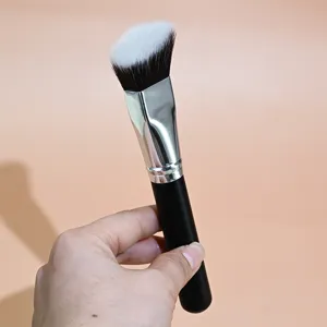 Detailed close-up of the angled triangular foundation brush for smooth makeup application.
