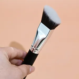 Detail shot of angled foundation brush with soft synthetic bristles and sleek black handle.
