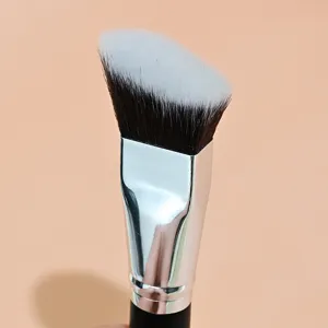 Detailed close-up view of angled makeup brush featuring soft bristles and silver ferrule.