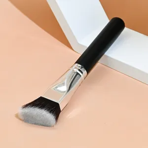 Detail view of angled foundation brush with black handle and soft synthetic bristles.