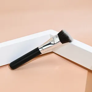 Angled makeup brush detail showing soft bristles, silver ferrule and black handle for seamless foundation.