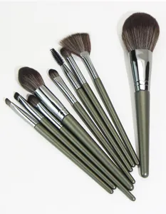 Detailed view of the 9-piece makeup brush set with dark green handles and soft bristles.
