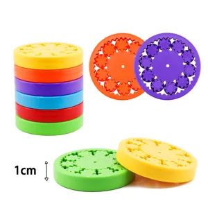 Colorful plastic gear disk toys, interlocking geometric sprograph puzzle for creative play.
