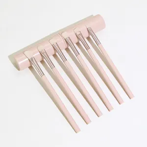 Detail view of the 6-piece pink makeup brush set with elegant round storage container.