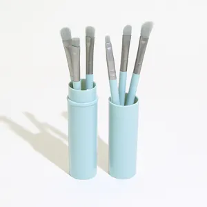 Portable light blue makeup brush set with 6 precision eye brushes in sleek storage tube.