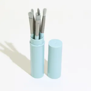 Portable makeup brush set with cute light blue round bucket case for easy daily travel use.