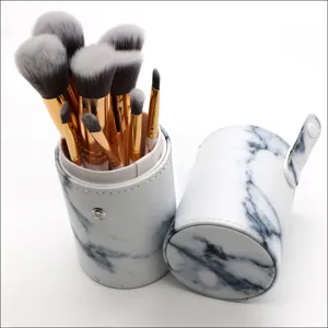 Detail view of 10-piece makeup brush set with elegant marble pattern PU holder and gold ferrules.