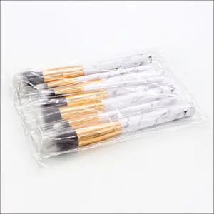 10-piece marble makeup brush set featuring soft synthetic bristles and elegant gold handles.