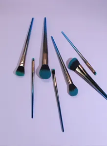 Professional 7-piece makeup brush set with gradient blue handles, detailed flat lay view.