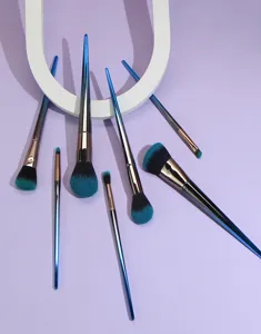 Professional 7-piece makeup brush set with gradient blue diamond handles and soft teal bristles.