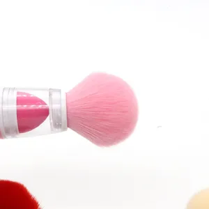 Detail shot of dual-use makeup brush with pink soft bristles and clear handle sponge design.