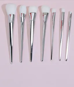 7-piece makeup brush set with silver diamond handles and white soft bristles for face and eyes.