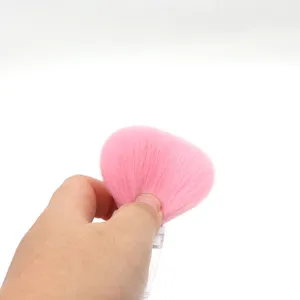Close-up detail of pink makeup brush bristles, soft synthetic fibers for smooth powder application.