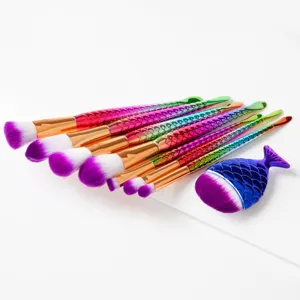 Mermaid makeup brush set detail view showing colorful fish tail handles and soft synthetic bristles.