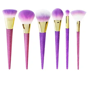 7-piece professional makeup brush set with purple glitter handles and soft gradient bristles.