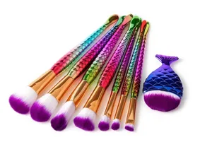 Detailed close-up of colorful mermaid tail makeup brushes with purple bristles for precise blending.