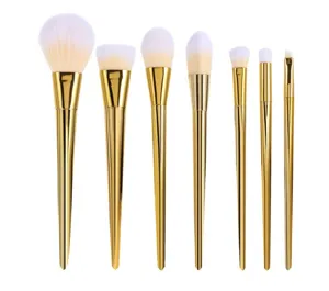Professional 7-piece makeup brush set with gold handles and soft white bristles for face makeup.